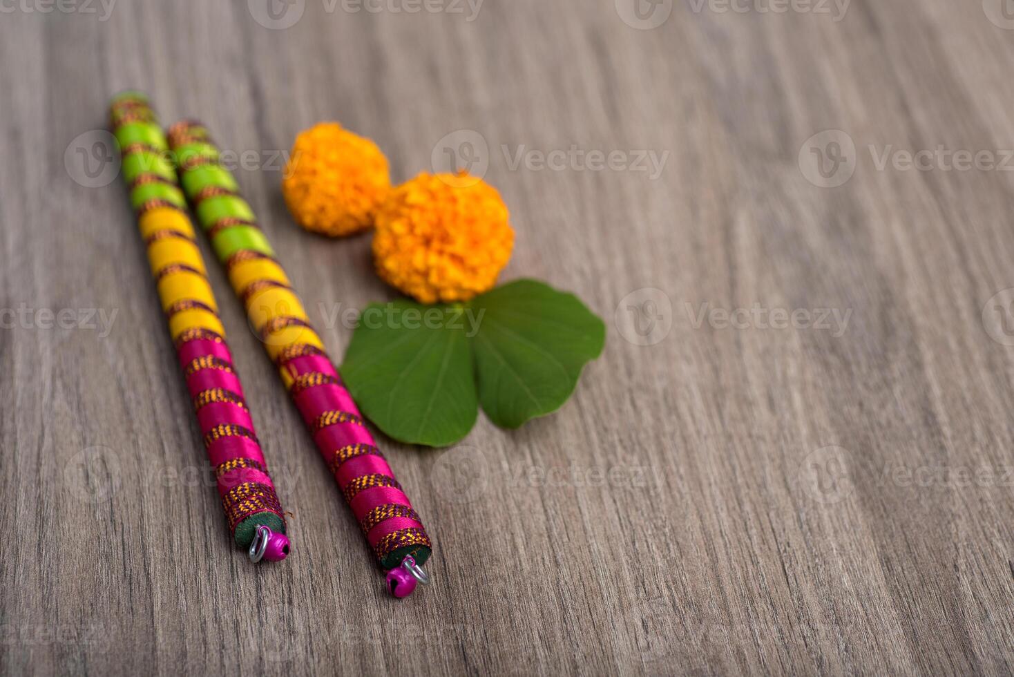 Two colorful sticks with flowers on a wooden table photo