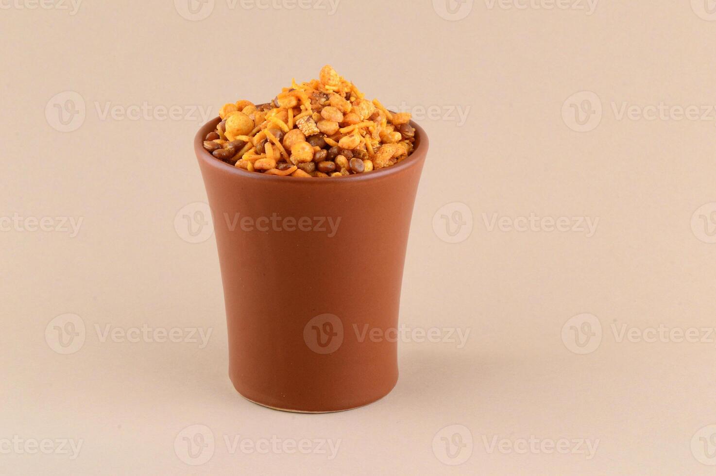 A brown cup filled with nuts and other food photo