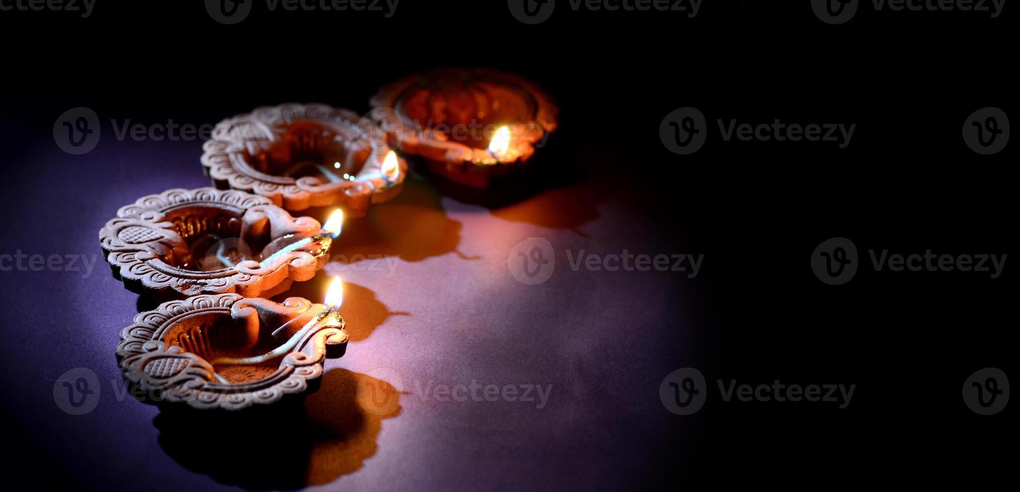 Three candles are lit in the dark photo