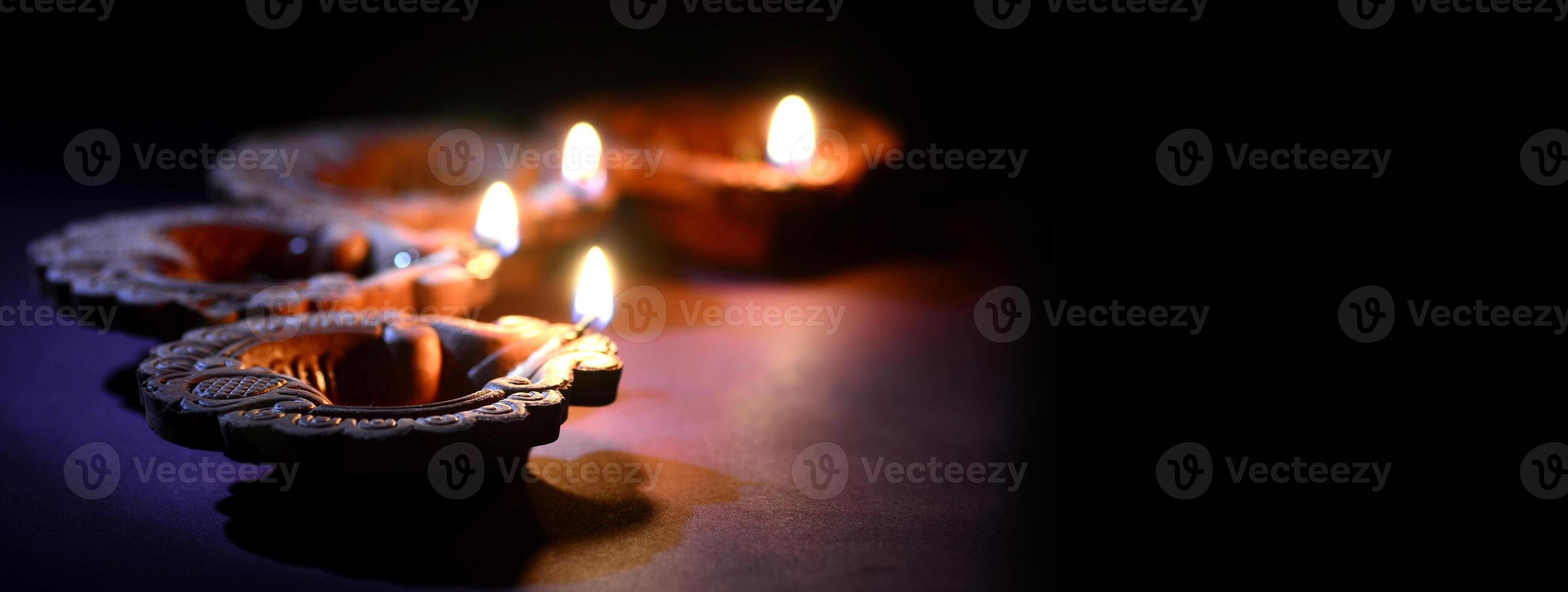 Three lit candles on a dark surface photo