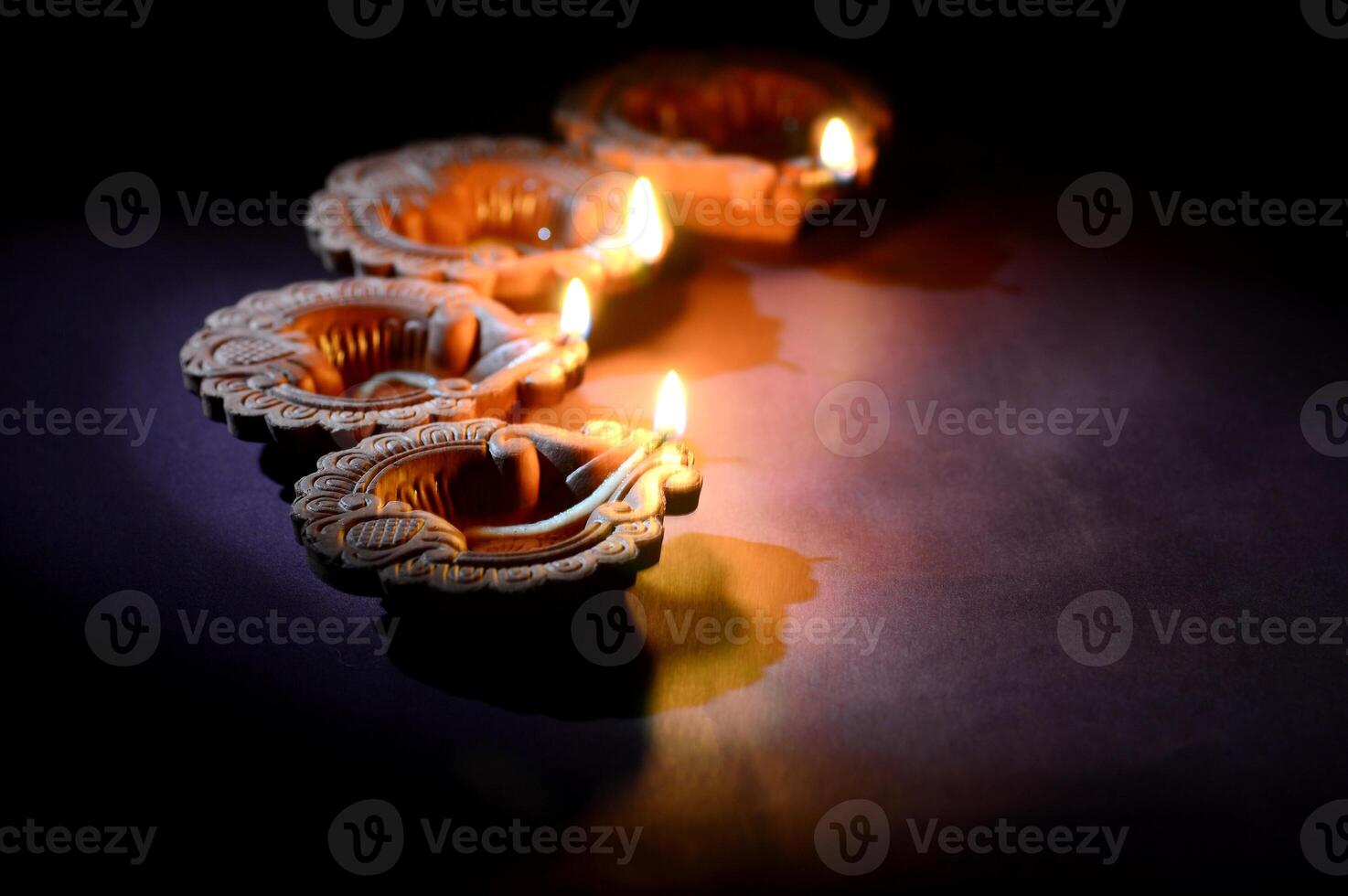 Three small candles are lit in a row photo