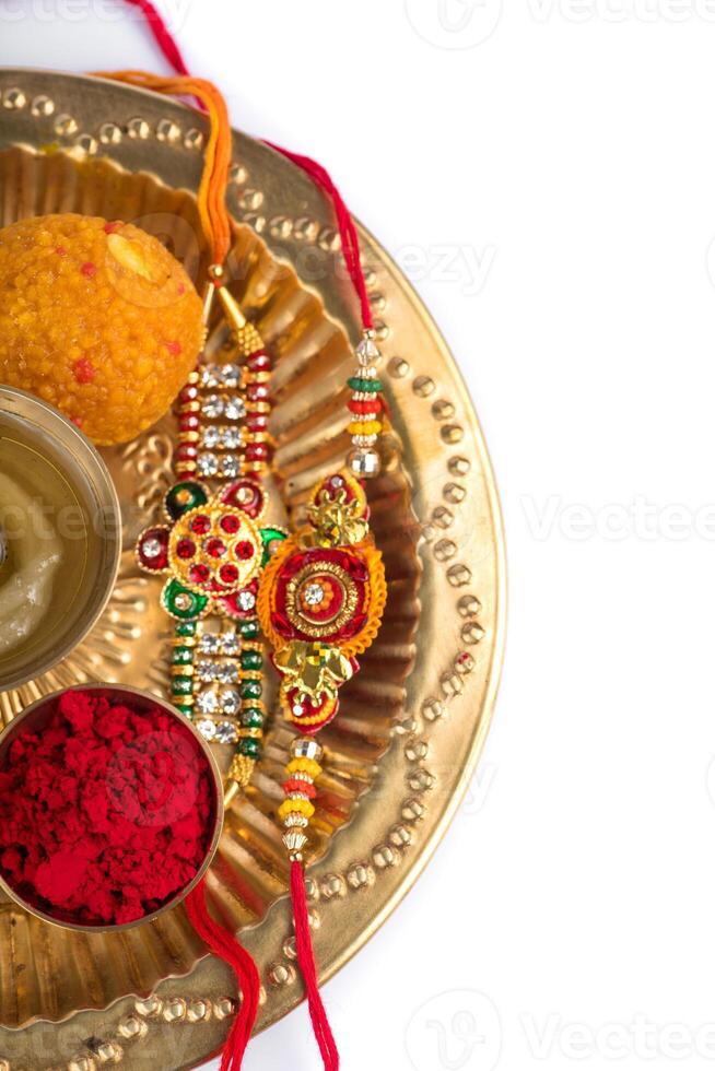 A plate with three different colored rakhi's on it photo