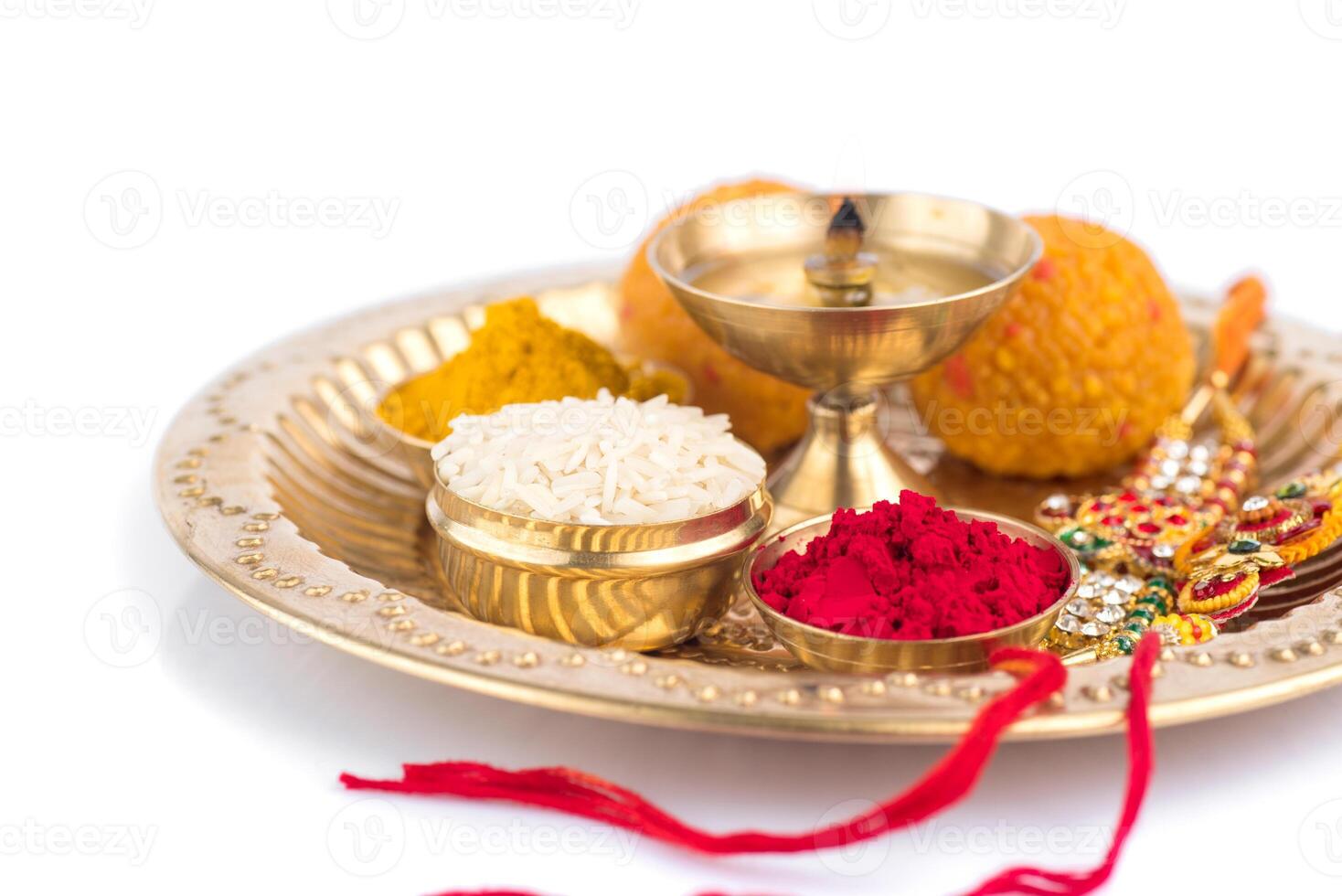 A gold plate with various colored powders and a red string photo