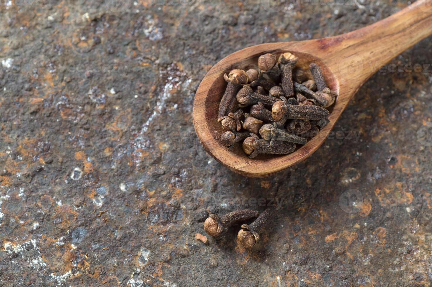 Cloves on a textured background. Spices, Food and cuisine ingredients. photo