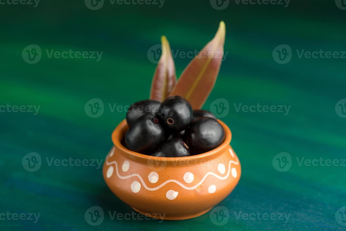 Jambolan plum or jambul or Jamun fruit, Java plum Syzygium cumini on textured background. photo