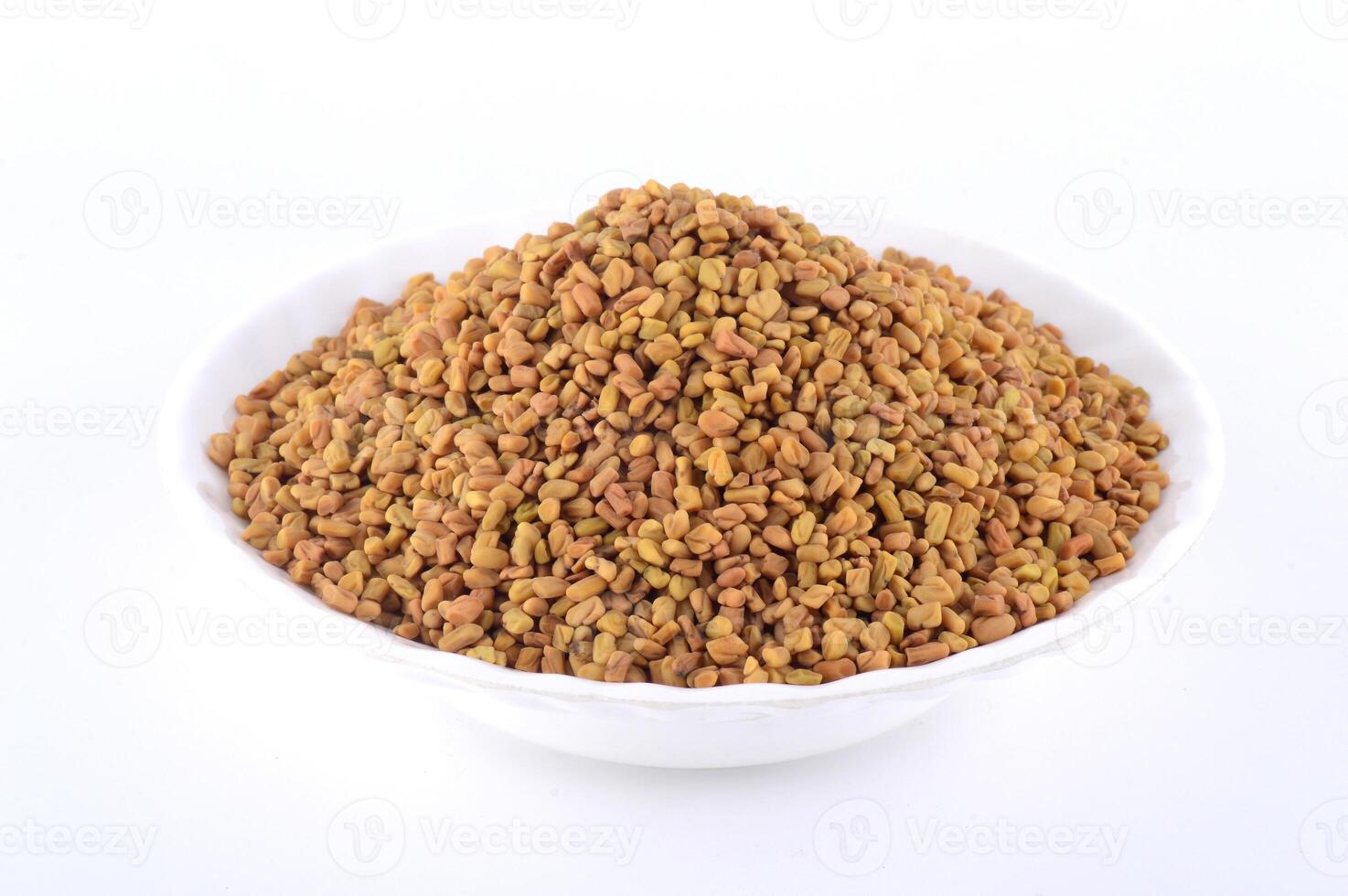 Fenugreek seeds in white plate isolated on white background photo