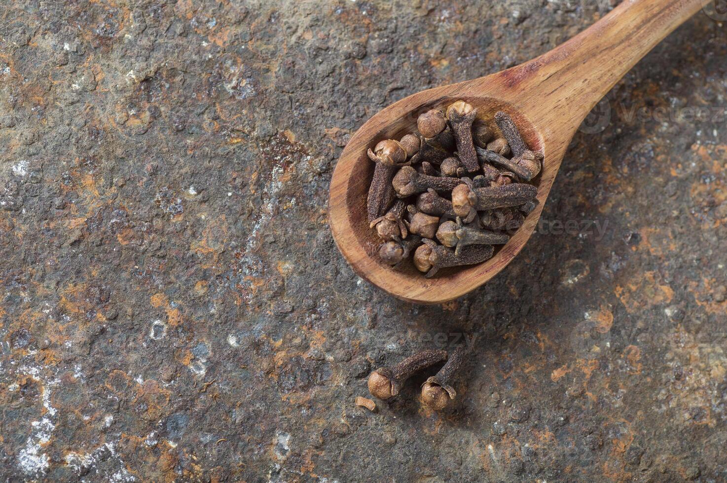 Cloves on a textured background. Spices, Food and cuisine ingredients. photo