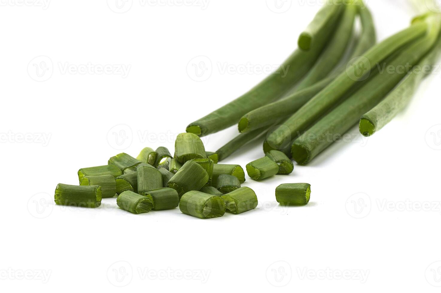 Fresh ripe green spring onions shallots or scallions with fresh chopped green onions on white background photo