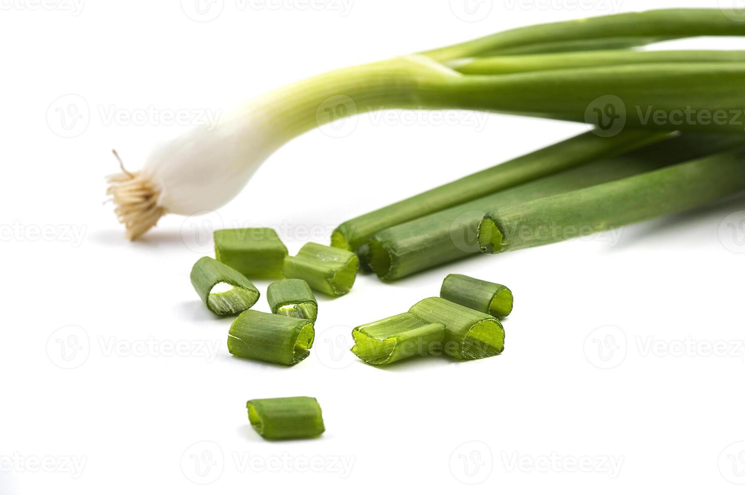 Fresh ripe green spring onions shallots or scallions with fresh chopped green onions on white background photo