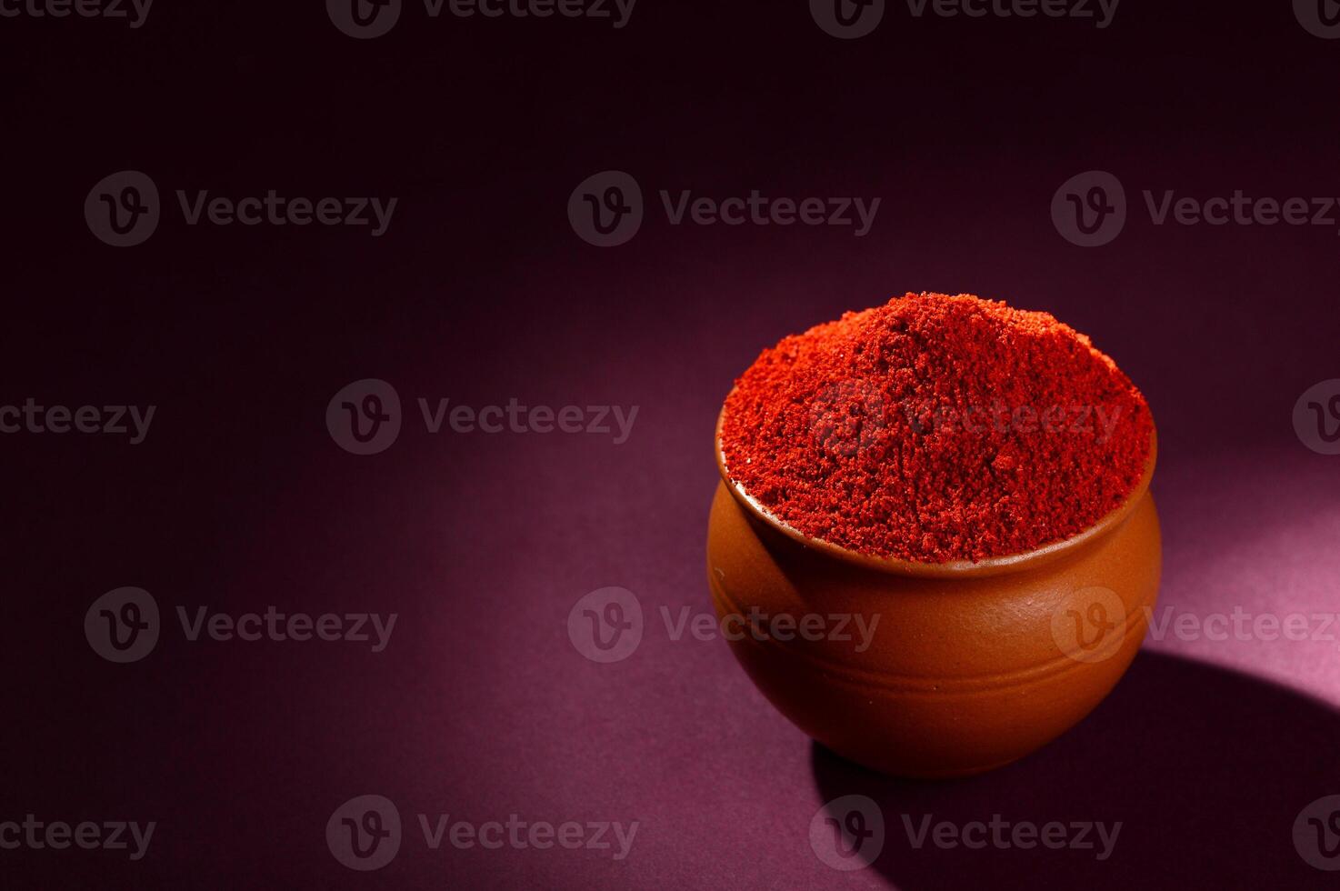 A close up of a red powder in a small pot photo