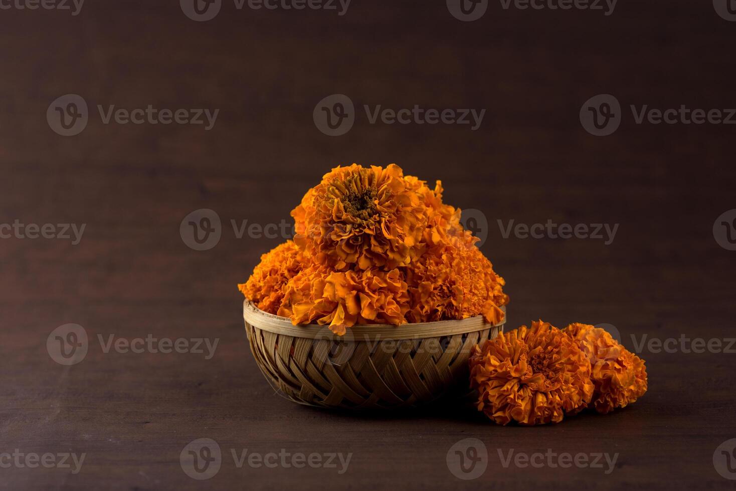 A basket with orange flowers sitting on a table photo