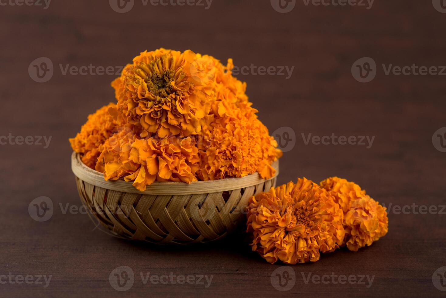 A basket filled with orange flowers on a table photo