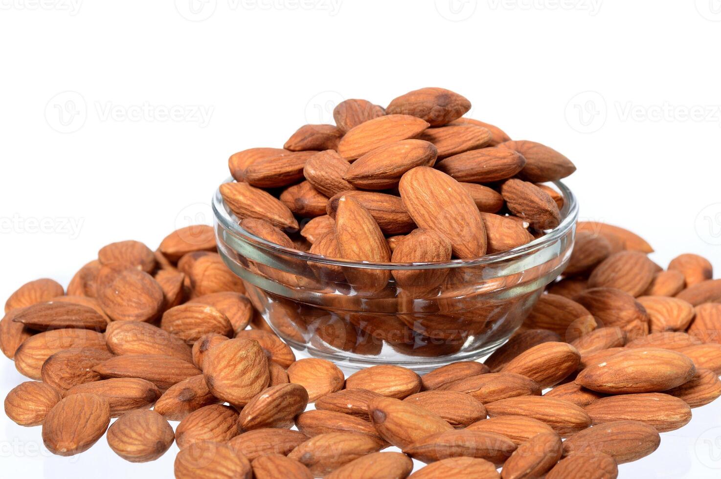 Almonds in a glass bowl on a white background photo