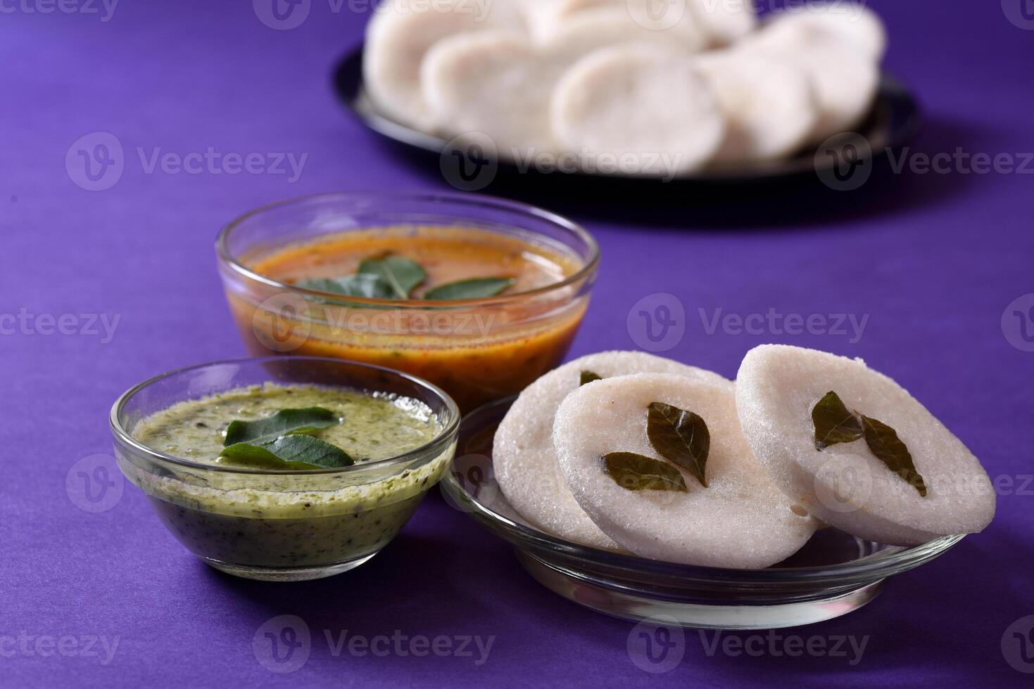 A bowl of rice with a small bowl of sauce and a small bowl of dumplings photo
