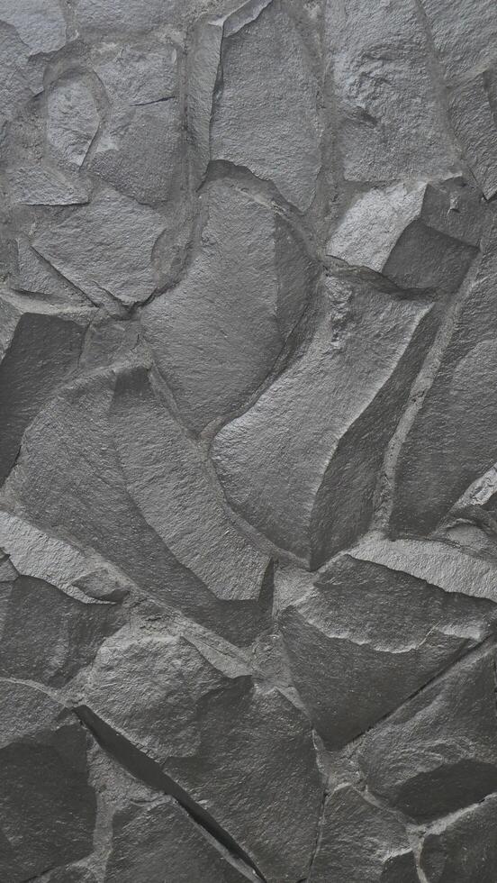 Grey rock stone texture portrait background wall pattern, top view. Background design for dark wallpaper. photo