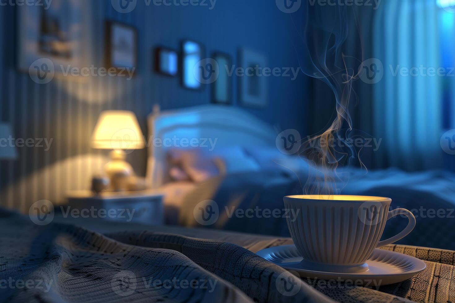 Steaming cup of drink resting on bed in a cozy dark bedroom photo