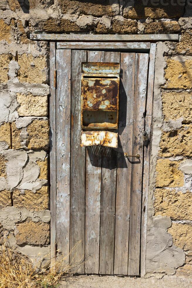 Old front door with mailbox and peeling paint. photo