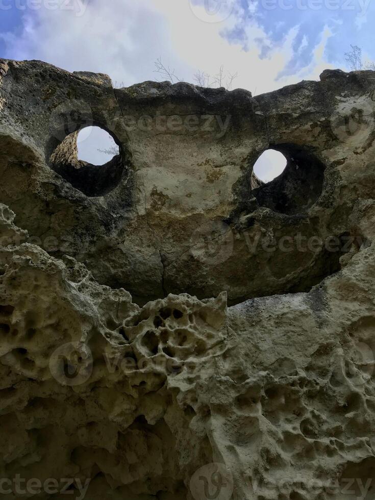 Natural rock in the form of a flying demon. Smiling bat. Bakla, Crimea. photo