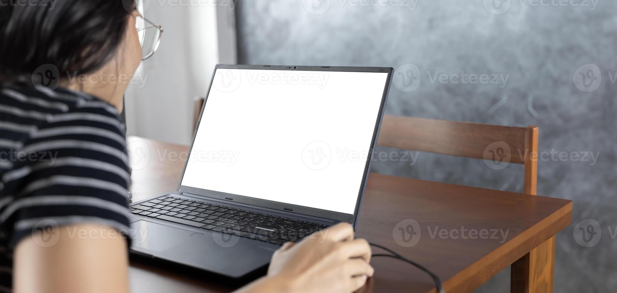Business woman worker or student elearning looking at white mock up blank screen using laptop computer learning online, remote working, searching on web. photo