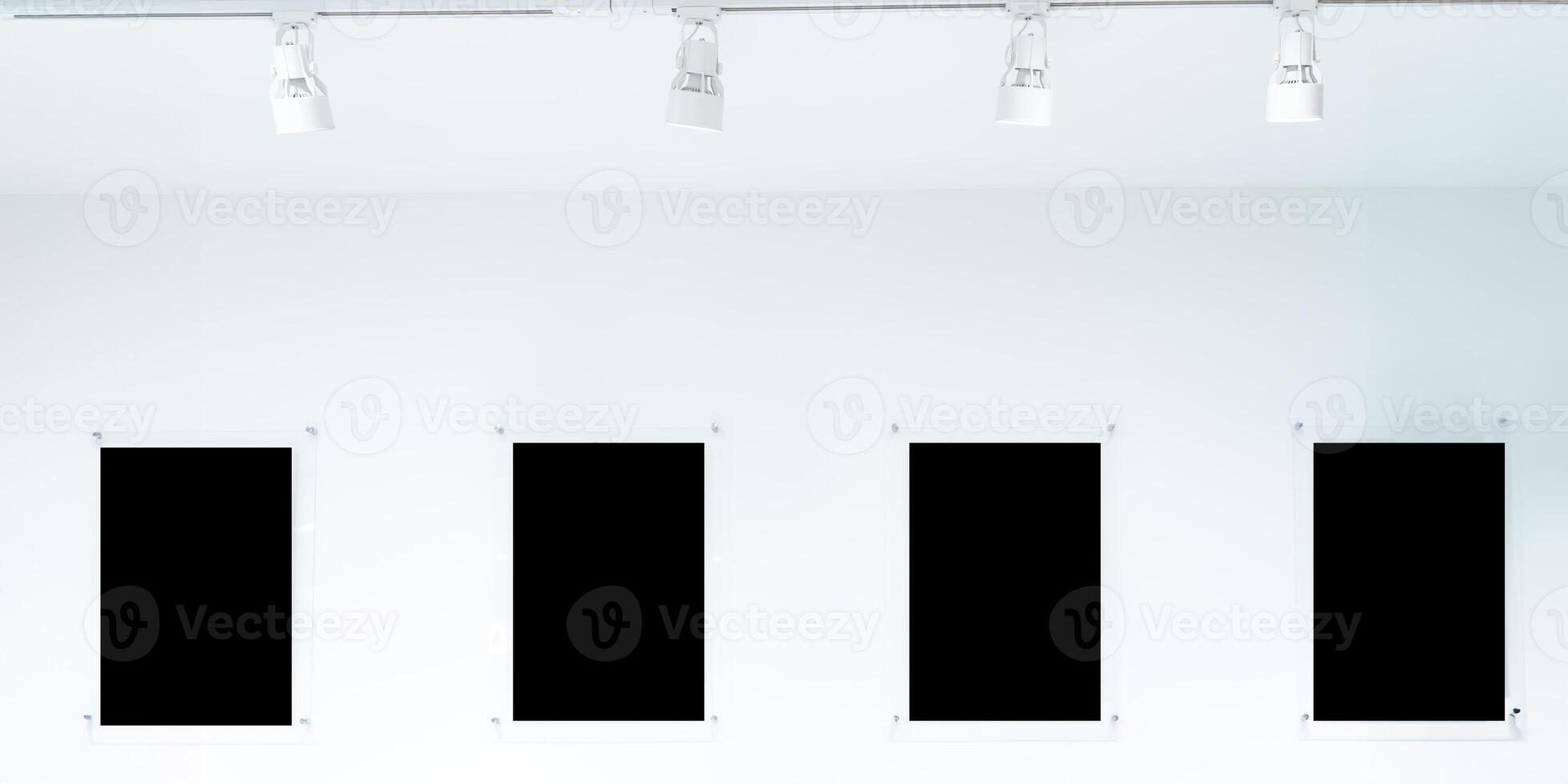 A row of black frames hang from a white wall. The frames are all different sizes and shapes, clipping path. photo