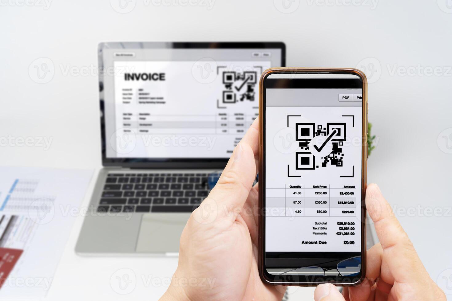 Woman scanning QR code from invoice to make payment using fast secure payment system and smartphone code reader. Business woman paying bills using express payment technology. photo