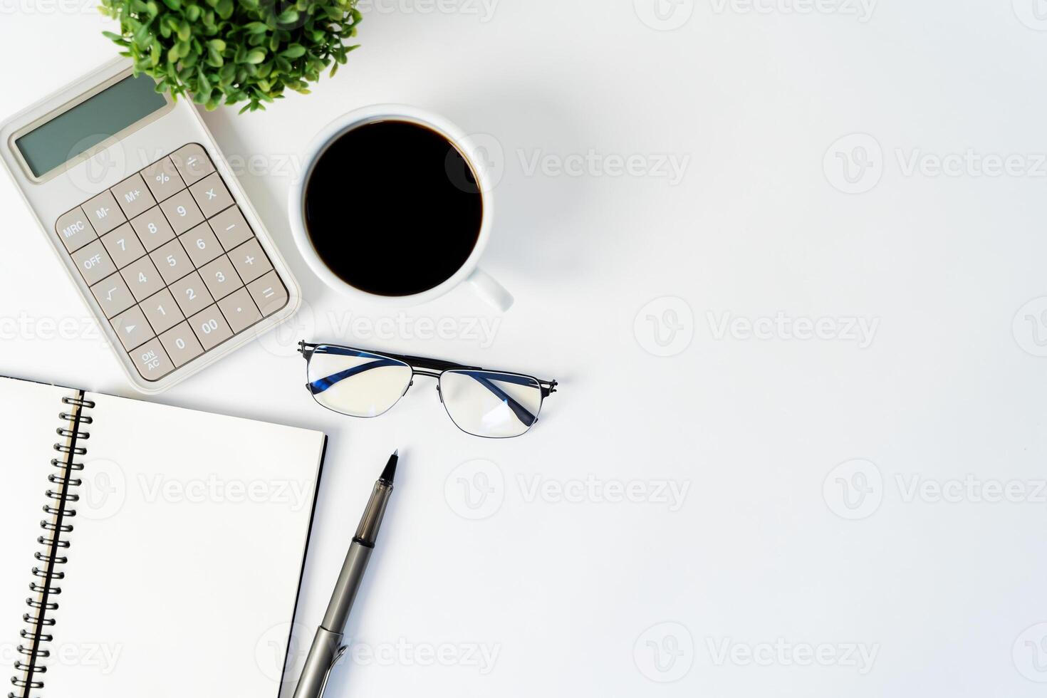 Work desk. Work desk. Top view of work space with calculator, pens, laptop on white background, copy space for blank text for quote. photo