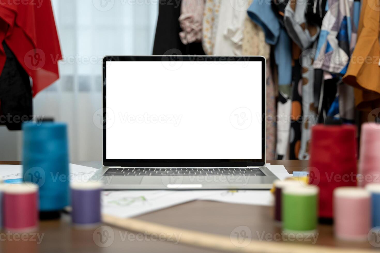 Mockup, design and a laptop screen for fashion, maunfacturing and clothing tailoring. Creative, blank and computer on a table for creativity. photo