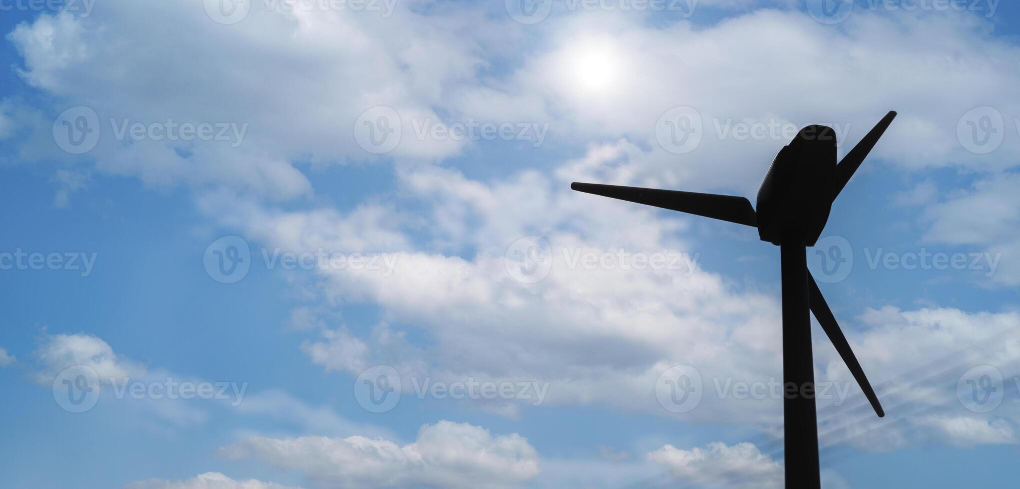 Wind turbines or wind turbines in a wind farm rotate to produce electricity outdoors with sun and blue sky, conservation. photo