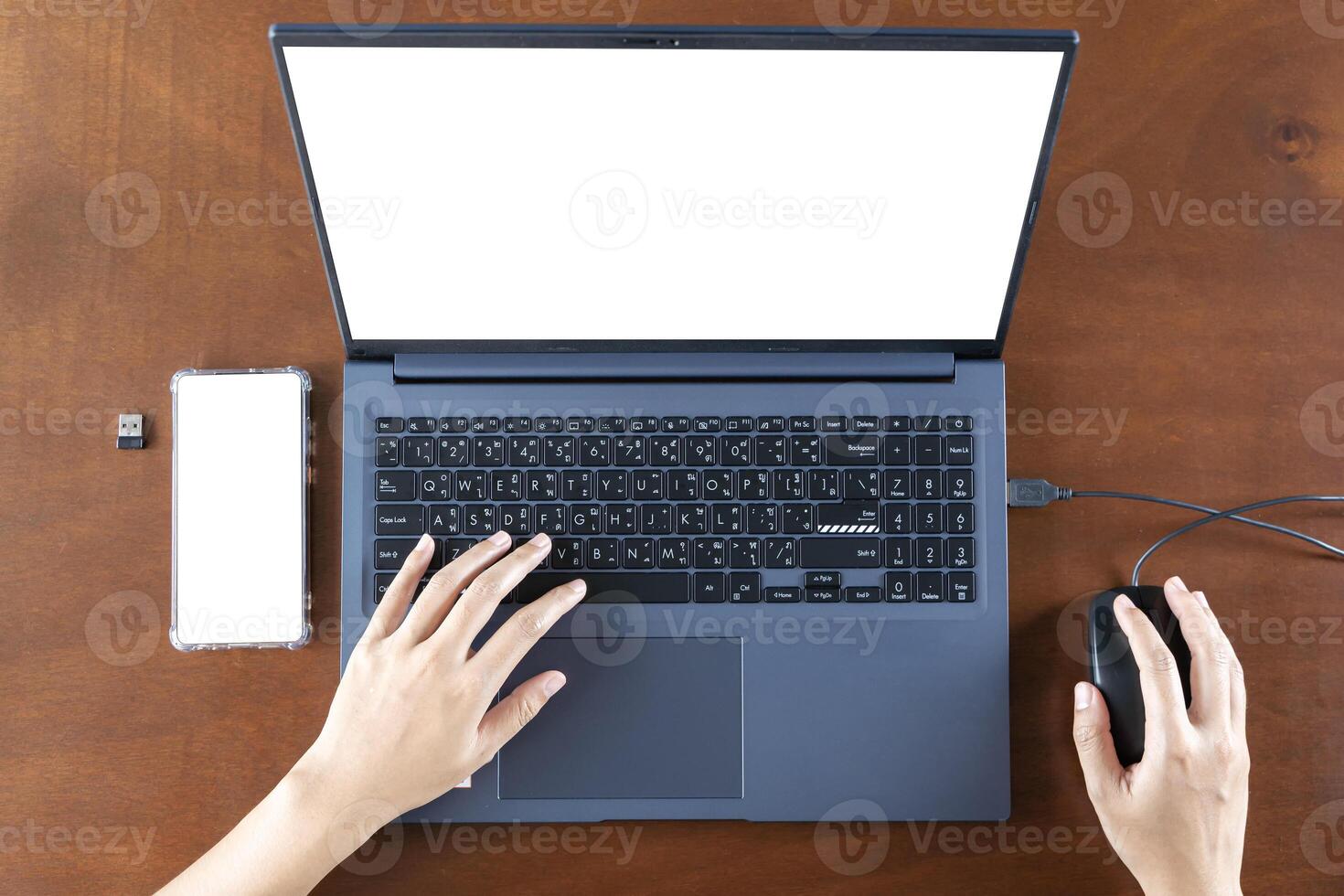 Close up businesswoman using smartphone and laptop with empty white blank screen mockup, sitting at desk, employee worker consulting client online. photo