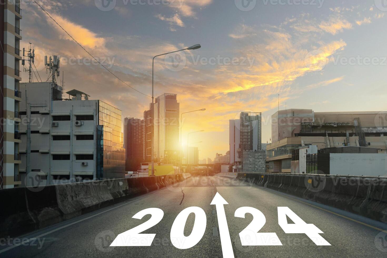 New year 2024 or straight forward concept. Text 2024 written on the road in the middle of asphalt road with at sunrise. Concept of planning. photo