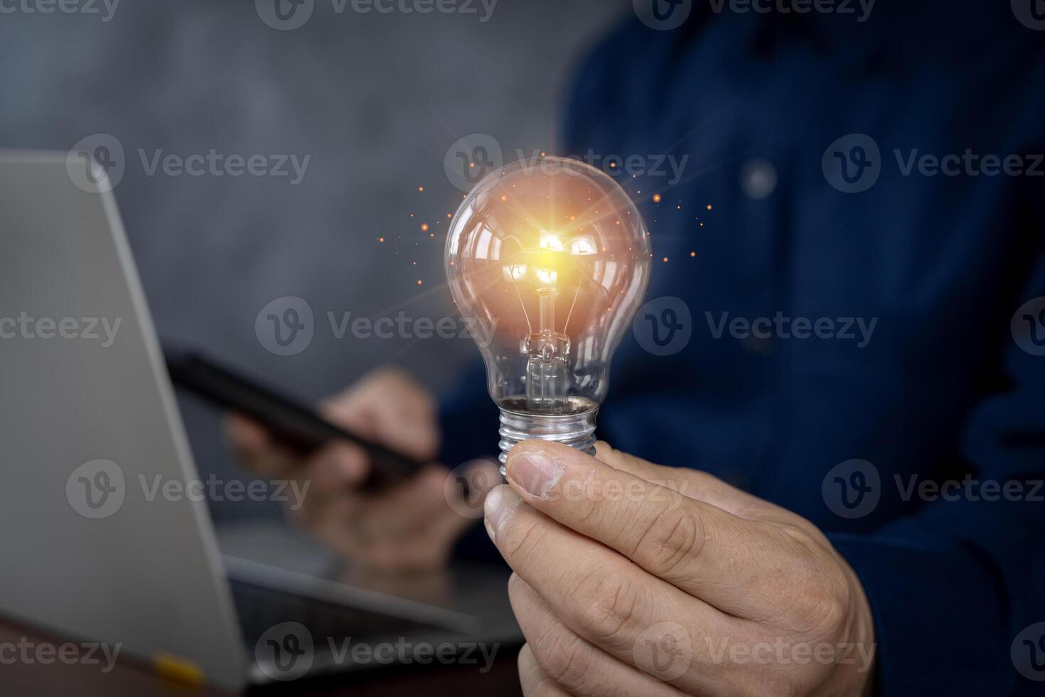 Creative businessman protects light bulb, symbolizing new ideas. Illustrates innovation brainstorming and solution concepts. photo