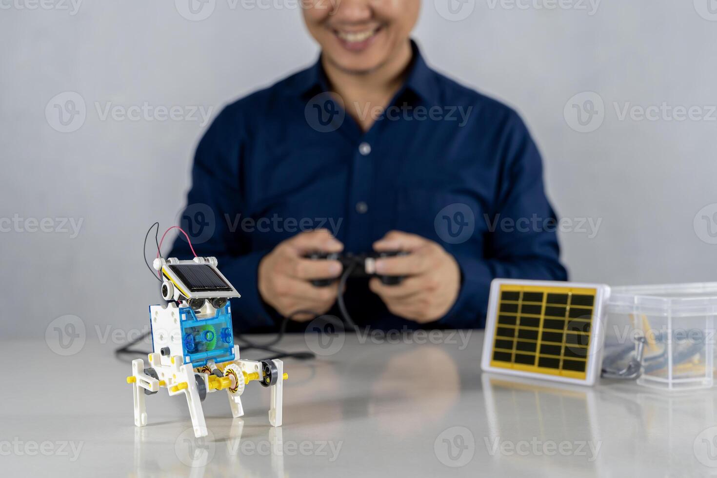 Child's hands working with circuits, wires, computer chip, OLED, motor, wheels on his robotics project. Science, Technology. photo