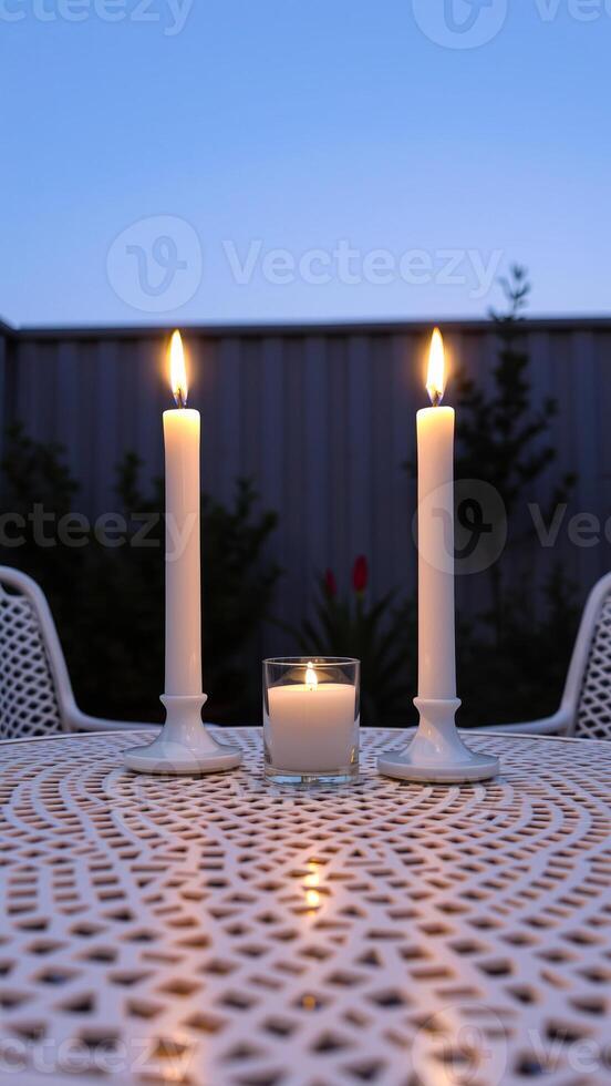 three white candles burning brightly on a white patterned table create a warm inviting ambiance. photo