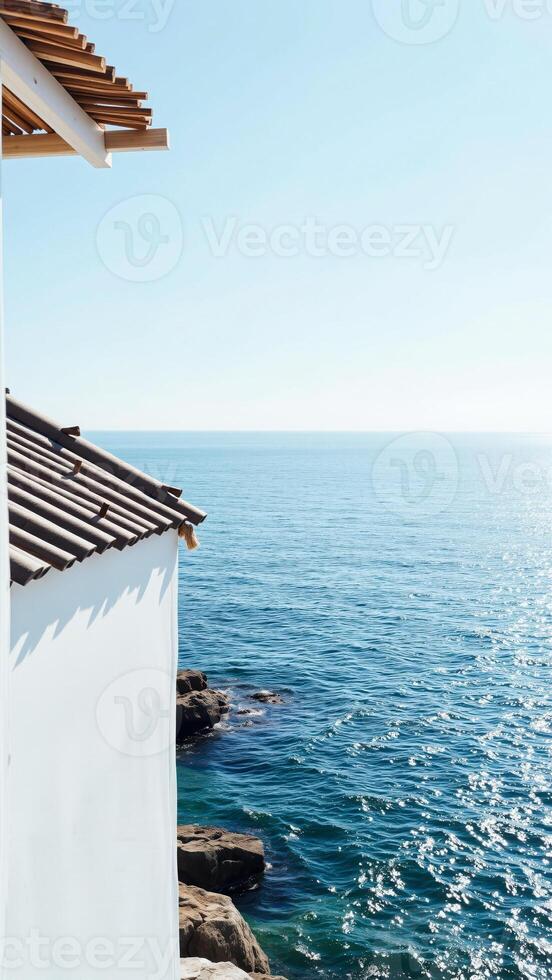 white building overlooking the blue ocean photo