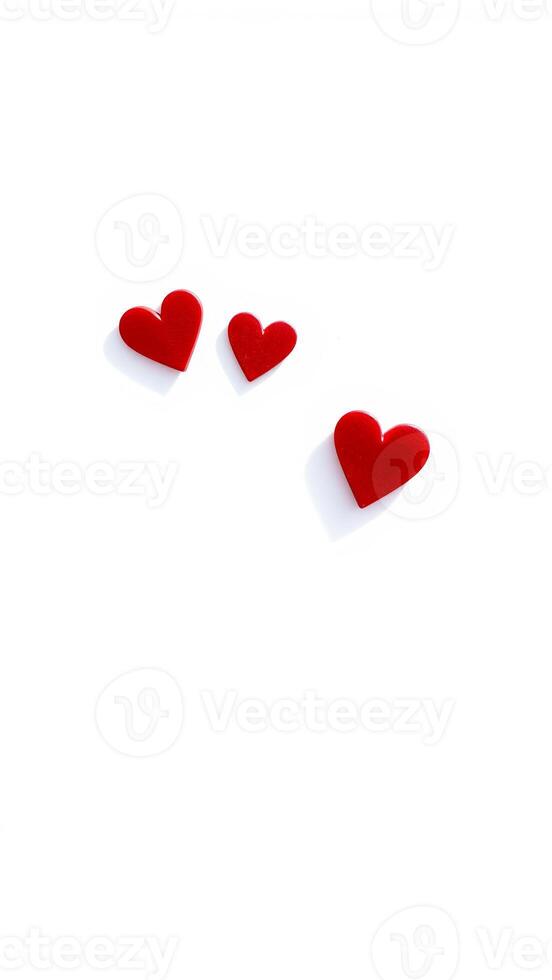three red heart shapes on a white background photo