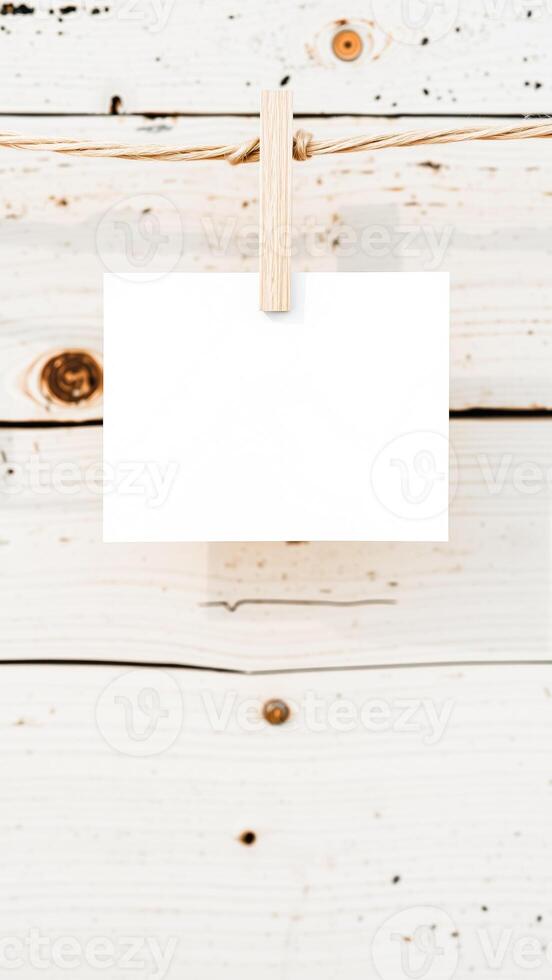 white paper hanging on a string with a wooden clothespin photo