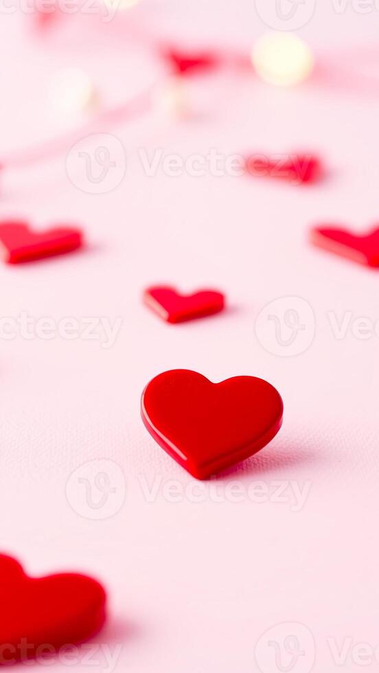 red hearts scattered on a pink background photo
