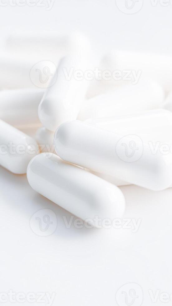 close- white capsules on a white surface photo