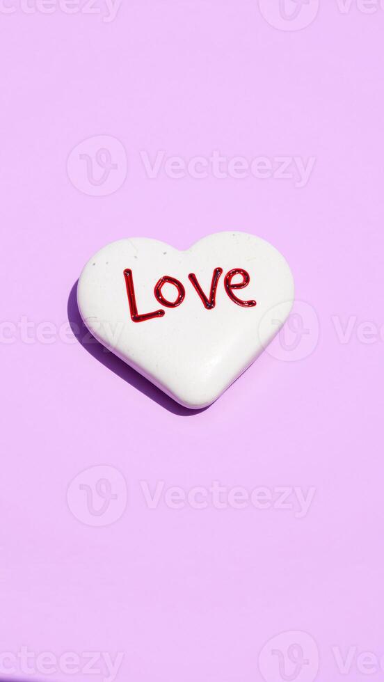 white heart with red love on purple background photo