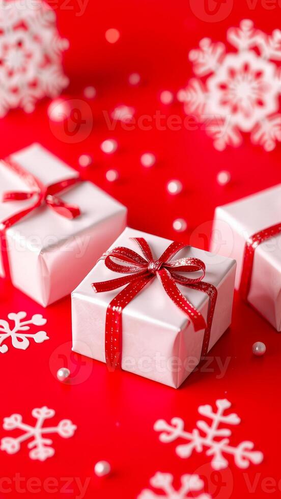 white gift boxes with red ribbons snowflake decorations on a red surface photo