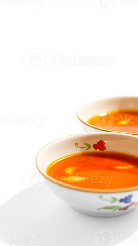 two floral bowls filled with bright liquid photo