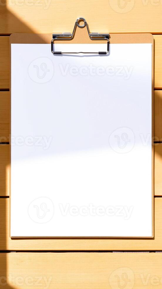 blank clipboard on a wooden surface photo