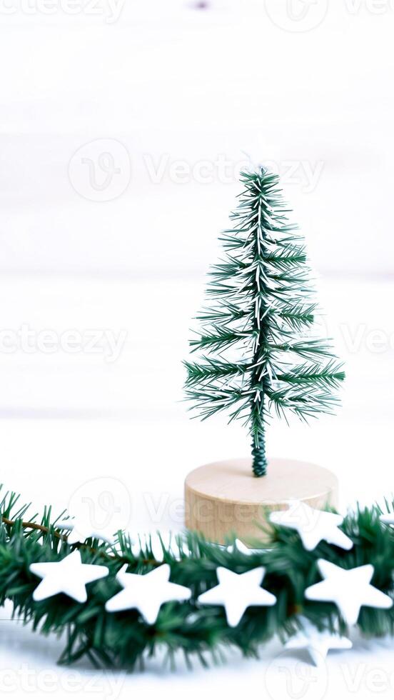 miniature snowy evergreen tree with star ornaments photo
