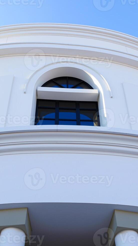 arched window on a white building photo