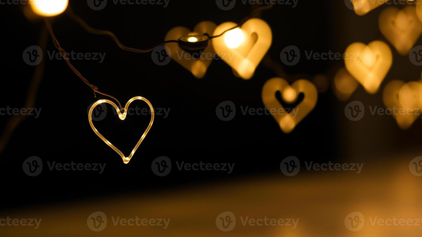 string heart-shaped lights emits a warm glow the darkness photo
