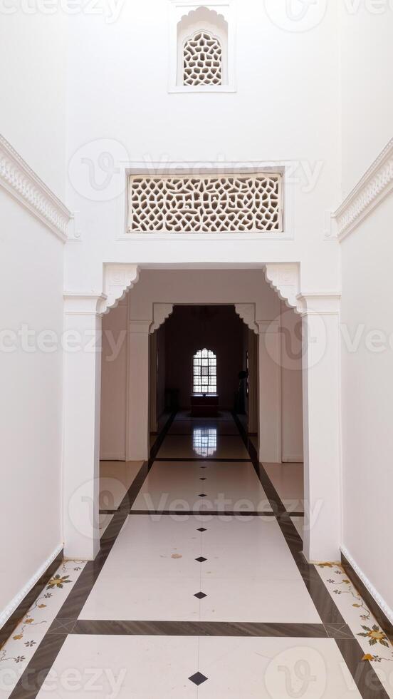 white hallway with an ornate window patterned tile floor photo