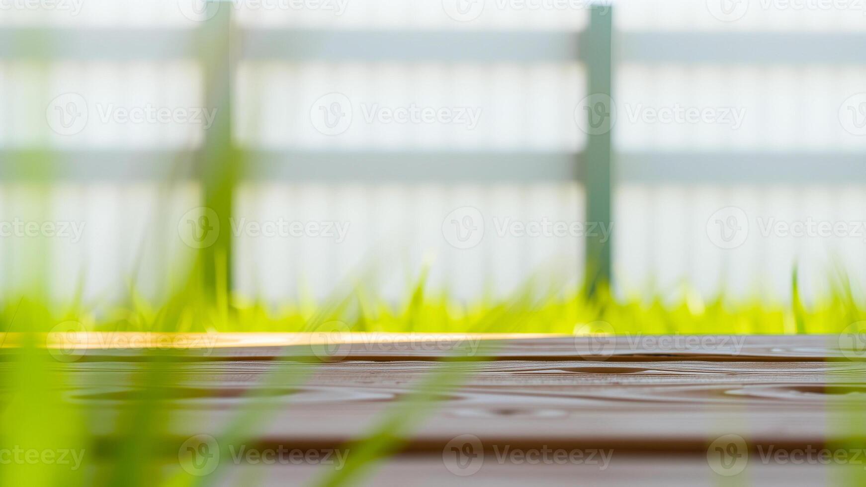 wooden surface with a blurred background a fence grass photo