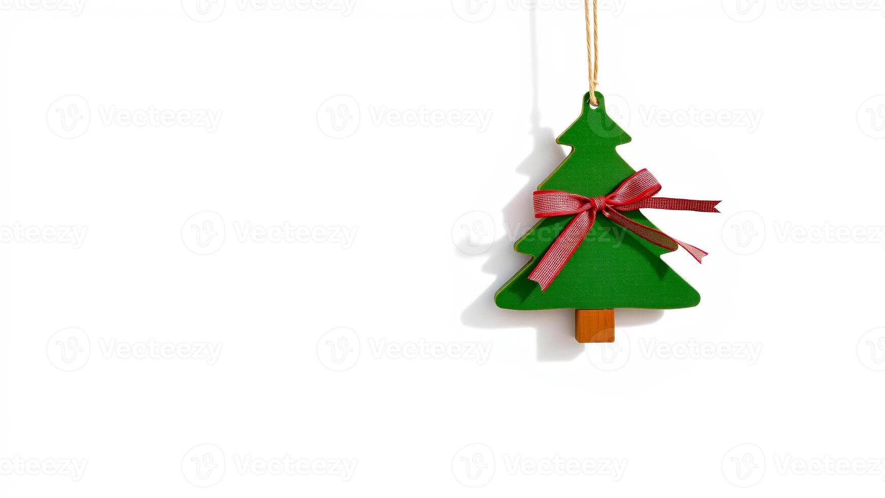 green wooden tree ornament with a red bow photo