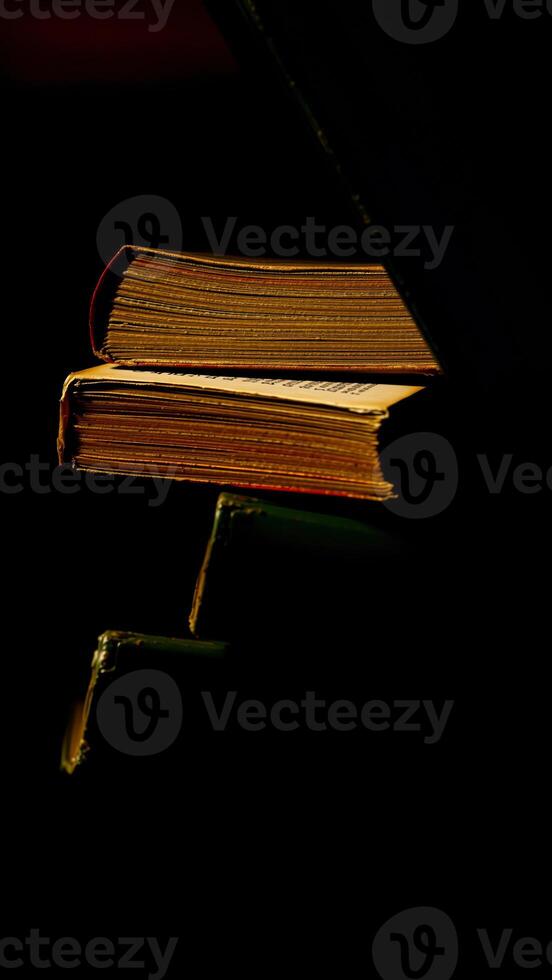 aged books stacked darkness photo