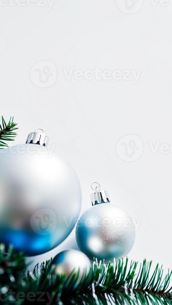 silver blue ornaments nestled a pine branch photo